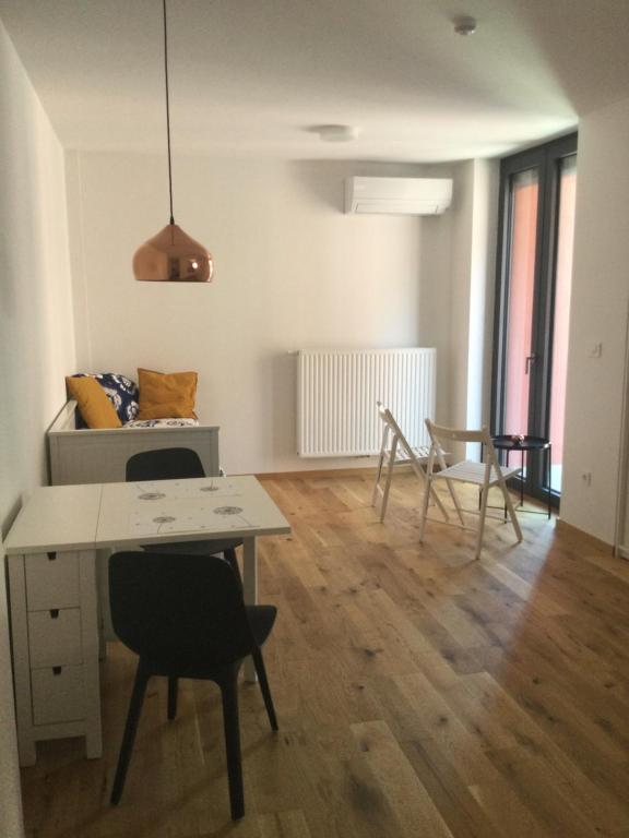 a living room with a table and chairs at Lovely studio appartment with patio near the sea in Koper