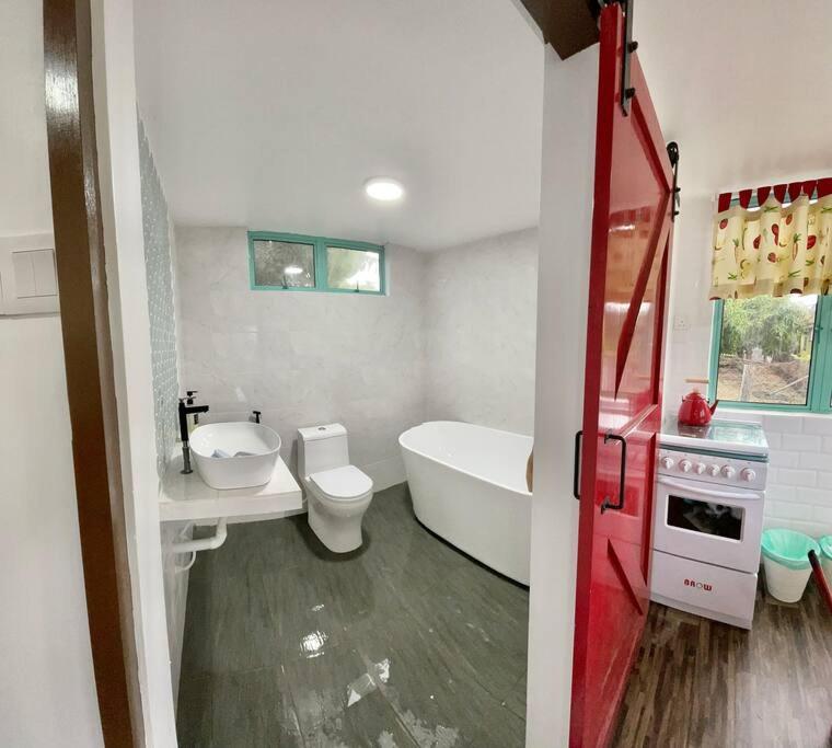 a bathroom with a tub and a toilet and a sink at Sea Kecil Tiny House near Jetty of Kuala Besut in Kampong Nail