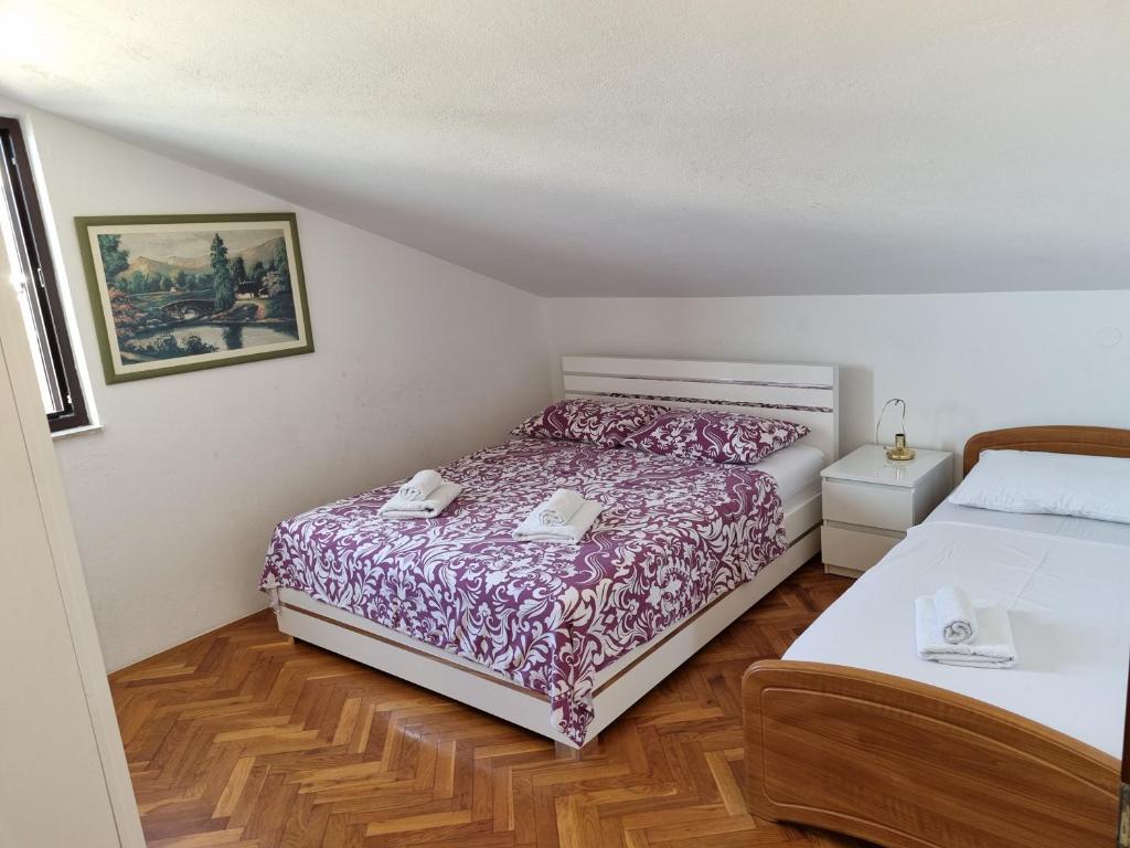 Postel nebo postele na pokoji v ubytování Apartments Villa Tanja