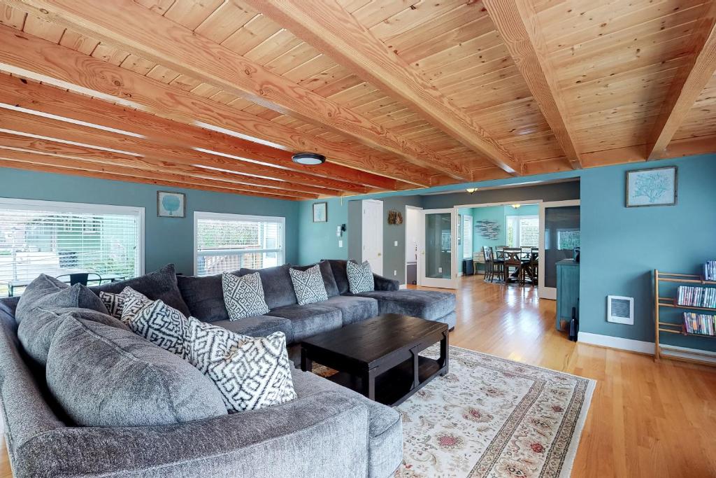 a living room with a couch and a table at Rocky Beach House by the Cove in Seaside