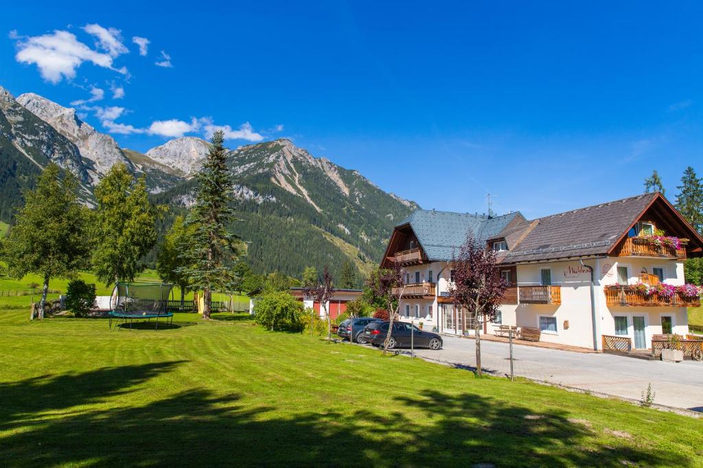 a view of a village with mountains in the background at Mühlrad Appartements in Ramsau am Dachstein