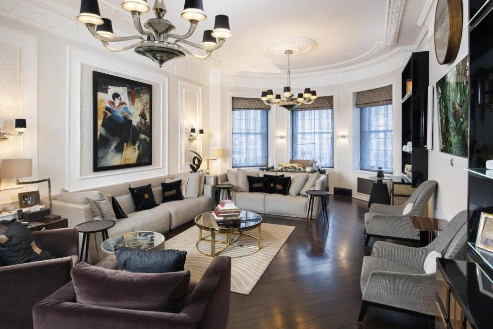 a living room filled with furniture and a chandelier at 6000sqft Apartment on Park Lane with Private Swimming pool,Gym&Sauna in London