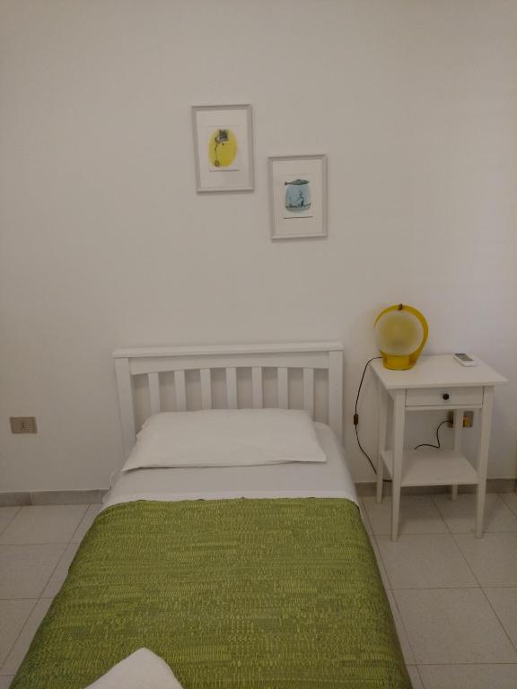 Łóżko lub łóżka w pokoju w obiekcie Villetta Porto Selvaggio