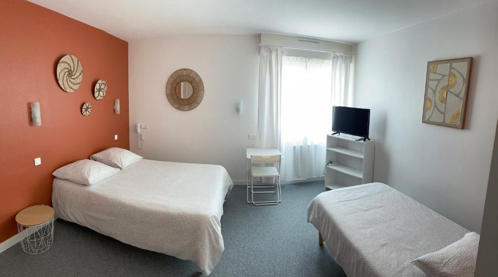 Postel nebo postele na pokoji v ubytování Hôtel du Littoral