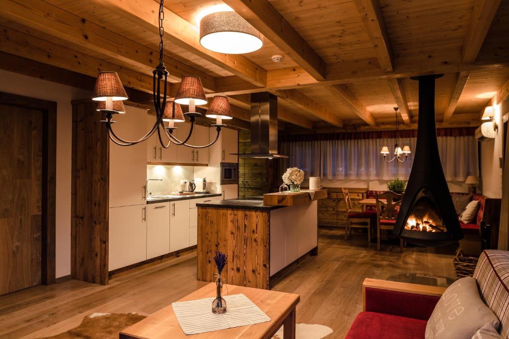 a living room with a couch and a table and a kitchen at Villa Resort & Luxury Chalet 6 in České Budějovice