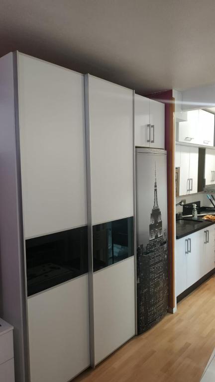 a kitchen with white cabinets with a view of a city at El Paraiso in Aguadulce