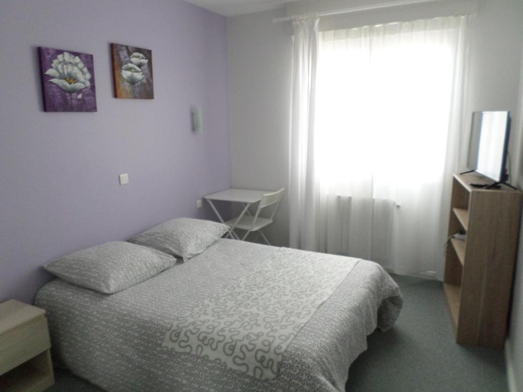 Postel nebo postele na pokoji v ubytování Hôtel du Littoral