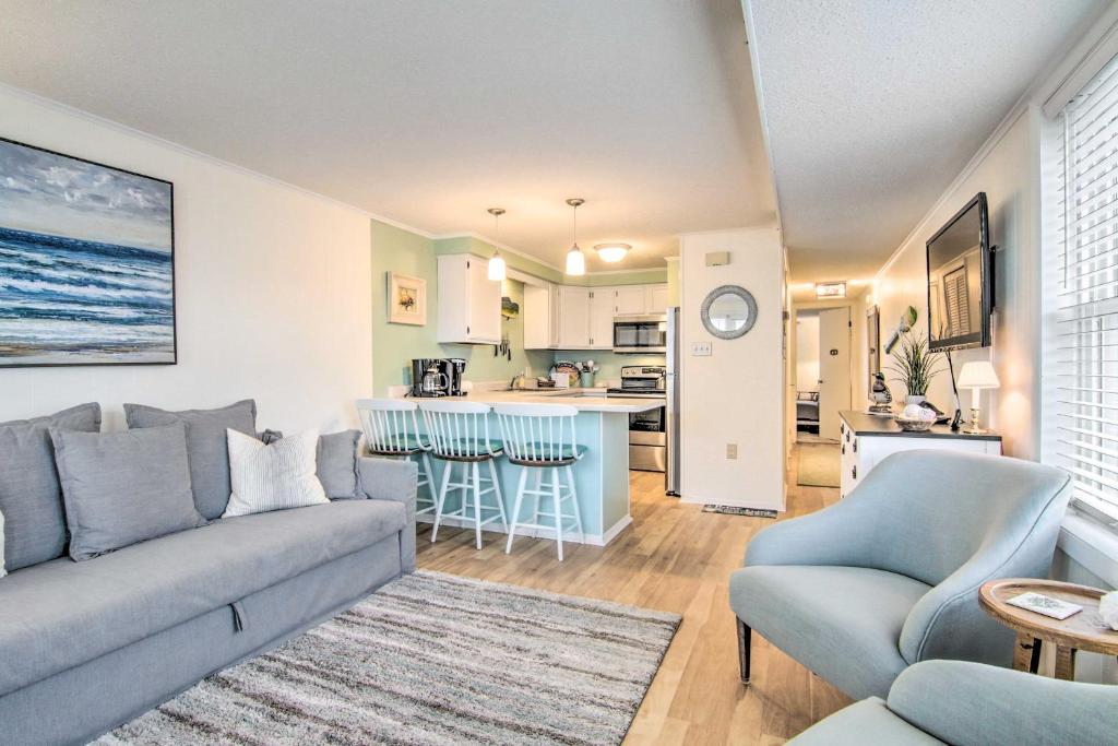 a living room with a couch and a kitchen at Walk to Maryland Beach Coastal Condo with Balcony in Ocean City