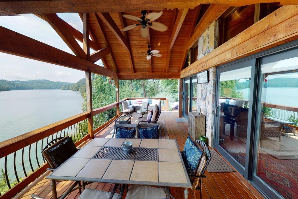 a screened in porch of a cabin with a table at Norris Lake Escape in New Tazewell