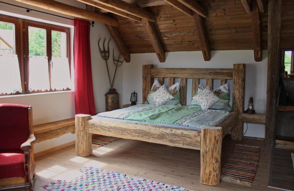 a bedroom with a wooden bed in a room at Tiefala's Eck in Stubenberg