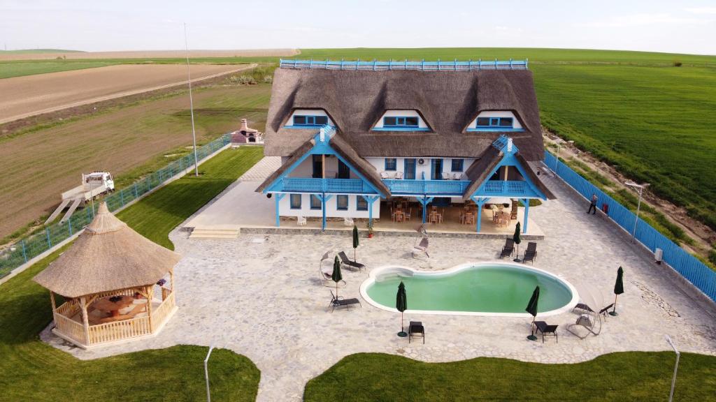 an aerial view of a large house with a pool at Pensiunea Dolosman in Jurilovca