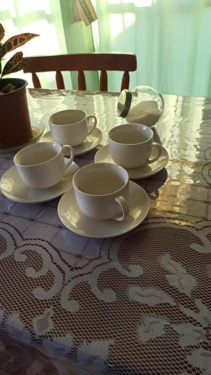 a table with four cups and saucers on it at La casita Bella Unión 