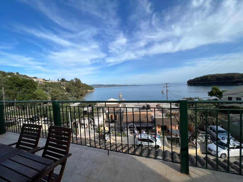 a balcony with a view of a body of water at Votsalo Pool Apts in Kalami