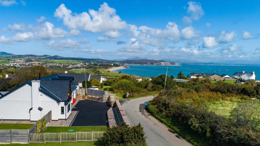 an aerial view of a town with the ocean at Spindrift in Abersoch