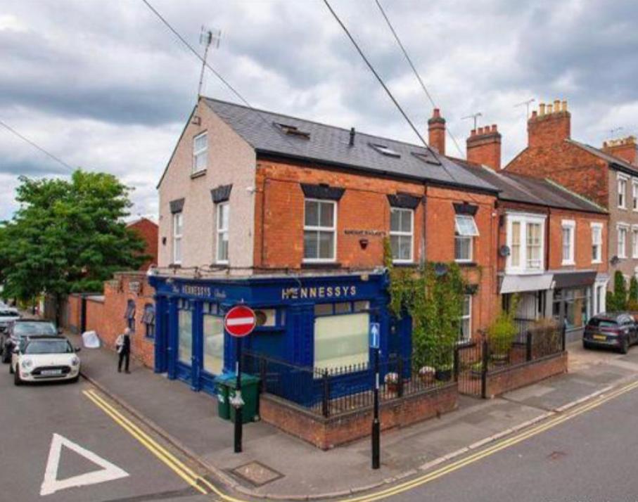a blue building on the corner of a street at Beautiful 5 bedroom house in great location. in Spon End