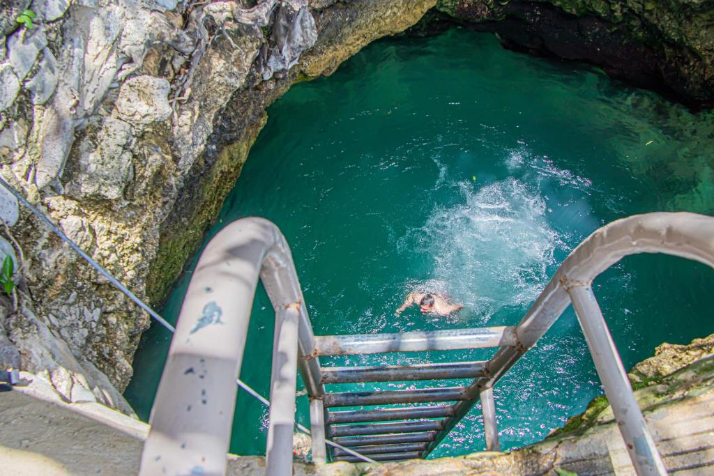 a water slide in a cave with a person in the water at Haleys Paradise At Blue Hole in Revival