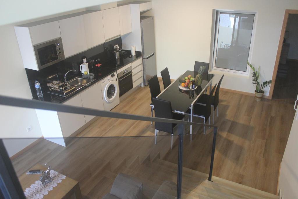 a kitchen and living room with a table and chairs at Torrinha & Sá in Funchal