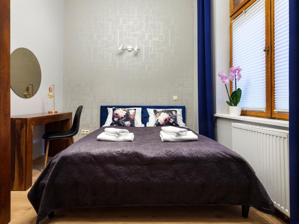Posteľ alebo postele v izbe v ubytovaní CracWoW Market Squere Apartment