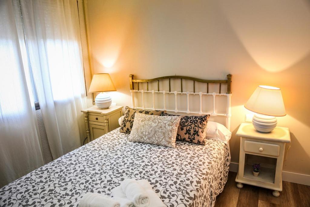 Postel nebo postele na pokoji v ubytování Apartamentos Baeza RN