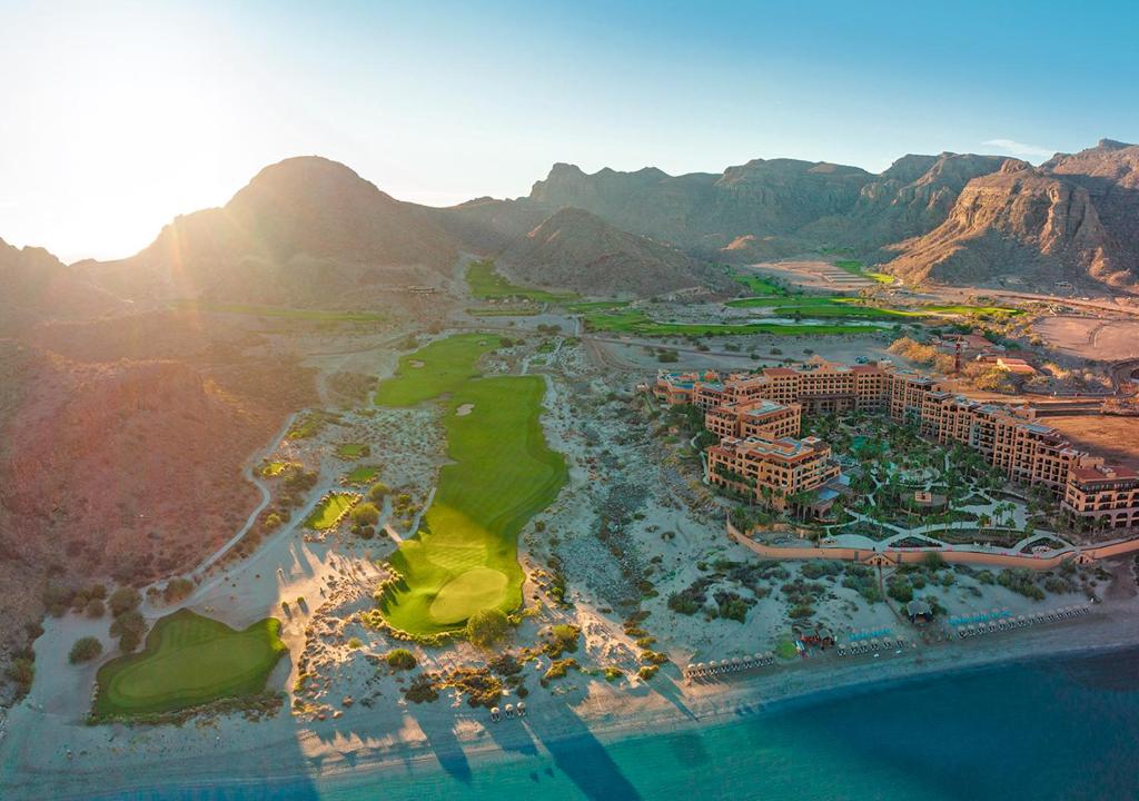 an aerial view of a resort with mountains in the background at Villa del Palmar at the Islands of Loreto in Loreto