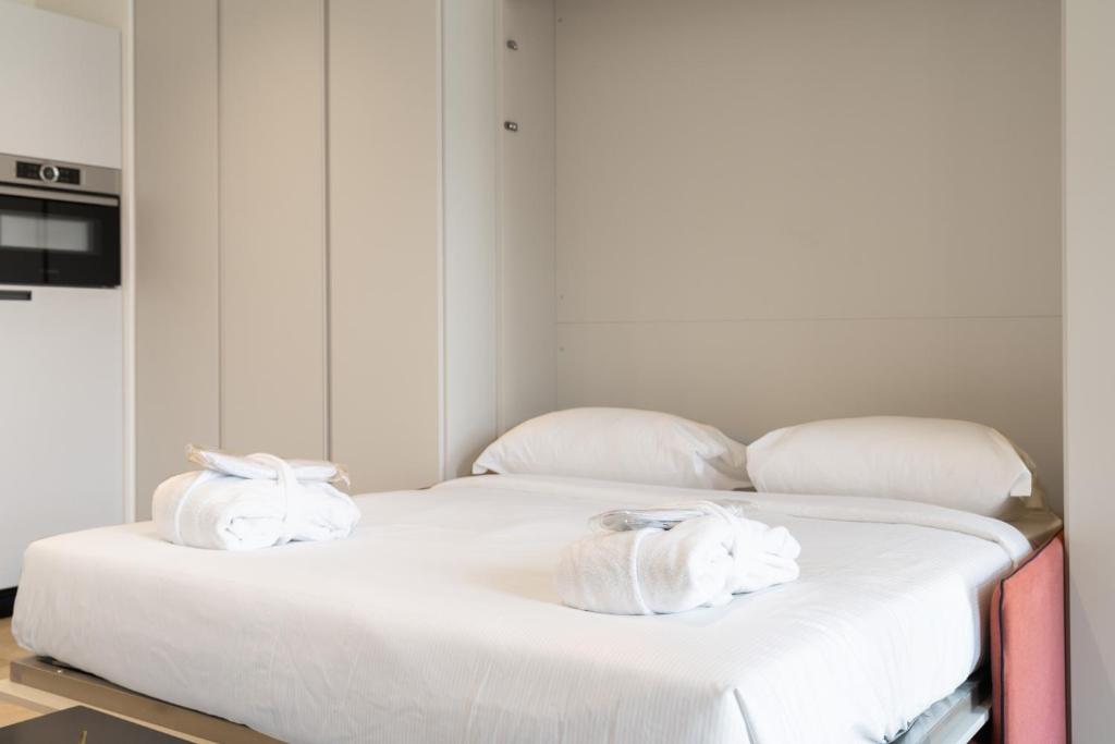 Postel nebo postele na pokoji v ubytování Swiss Hotel Apartments - Lugano