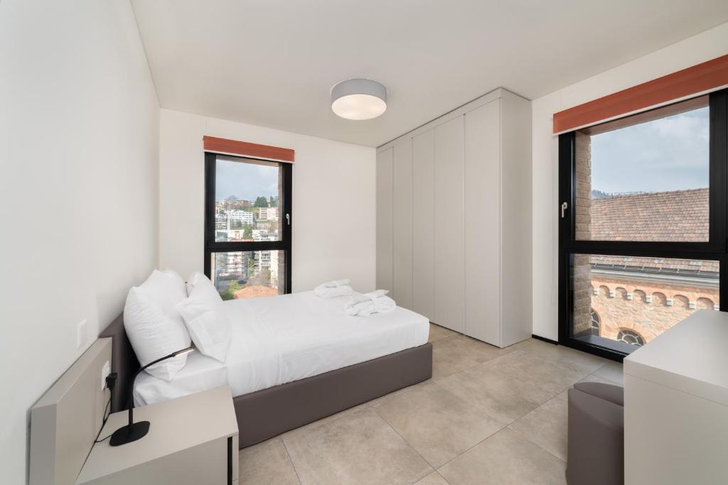Postel nebo postele na pokoji v ubytování Swiss Hotel Apartments - Lugano