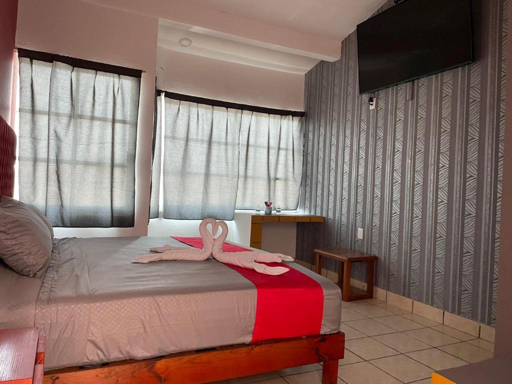 Postel nebo postele na pokoji v ubytování Hotel La Intimidad