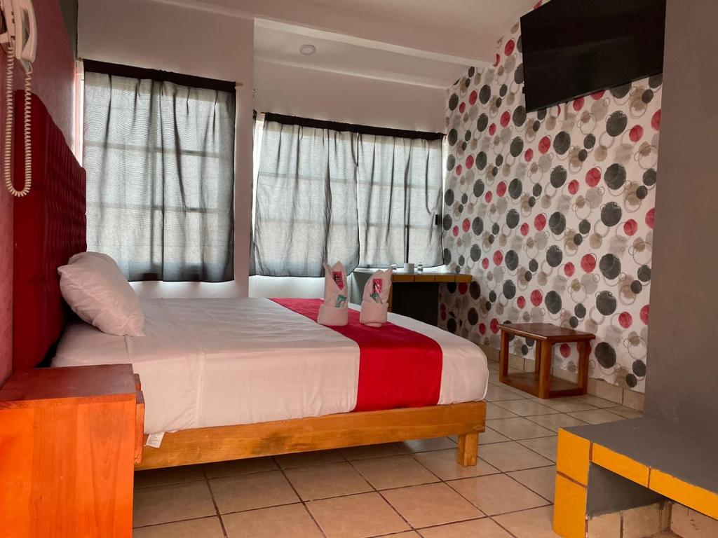 Postel nebo postele na pokoji v ubytování Hotel La Intimidad