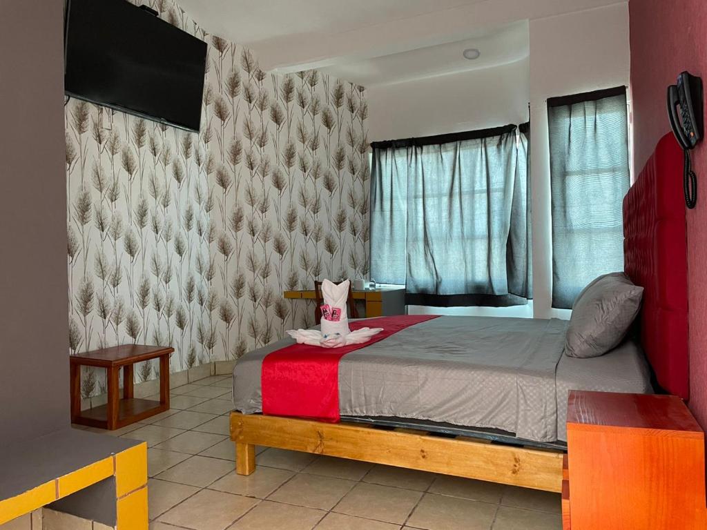 Postel nebo postele na pokoji v ubytování Hotel La Intimidad