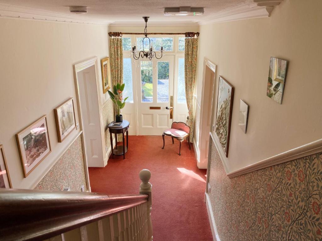 a hallway with a stairway with a stair case at Tyn Y Fron 6 bedroom house in Betws-y-Coed Snowdonia in Betws-y-coed