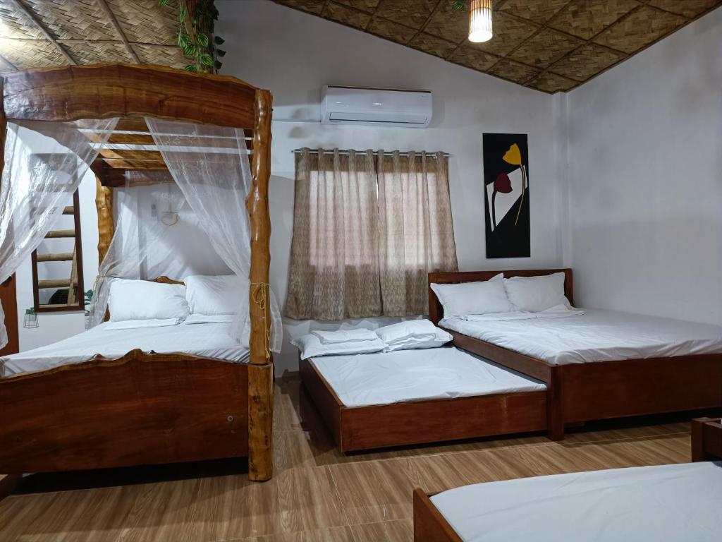 a bedroom with two bunk beds and a ladder at ANNI'S BEACH HOUSE in Lucena
