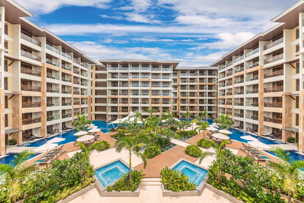 an aerial view of a resort with pools and palm trees at Henann Tawala Resort in Panglao