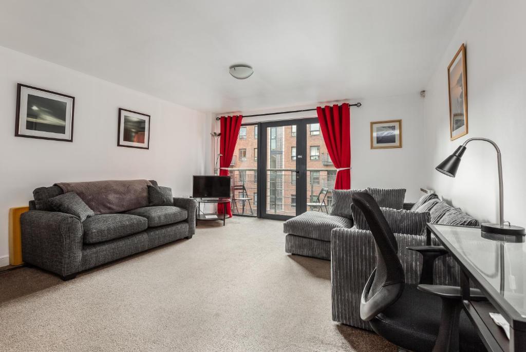 a living room with two couches and a table at Liverpool City Centre Apartments UK - East Village Duke Street in Liverpool