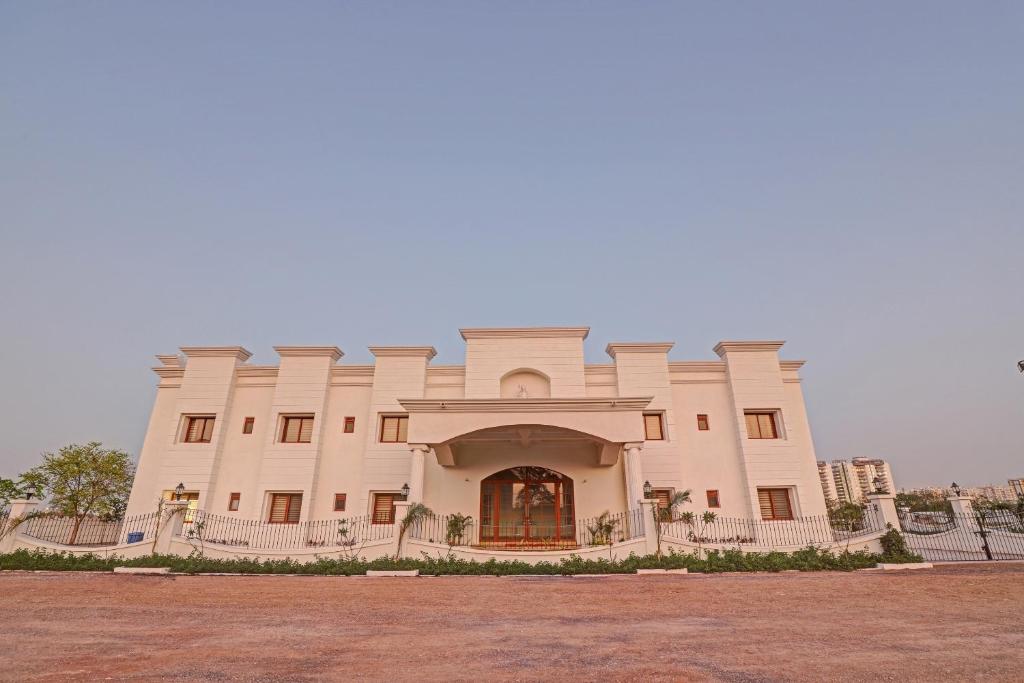 a large white building with a large entrance at Ratna Vilas Palace in Rajkot
