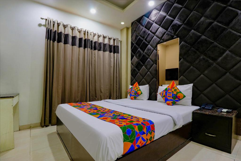 a bedroom with a large bed in a room at FabExpress Yug Villa in New Delhi