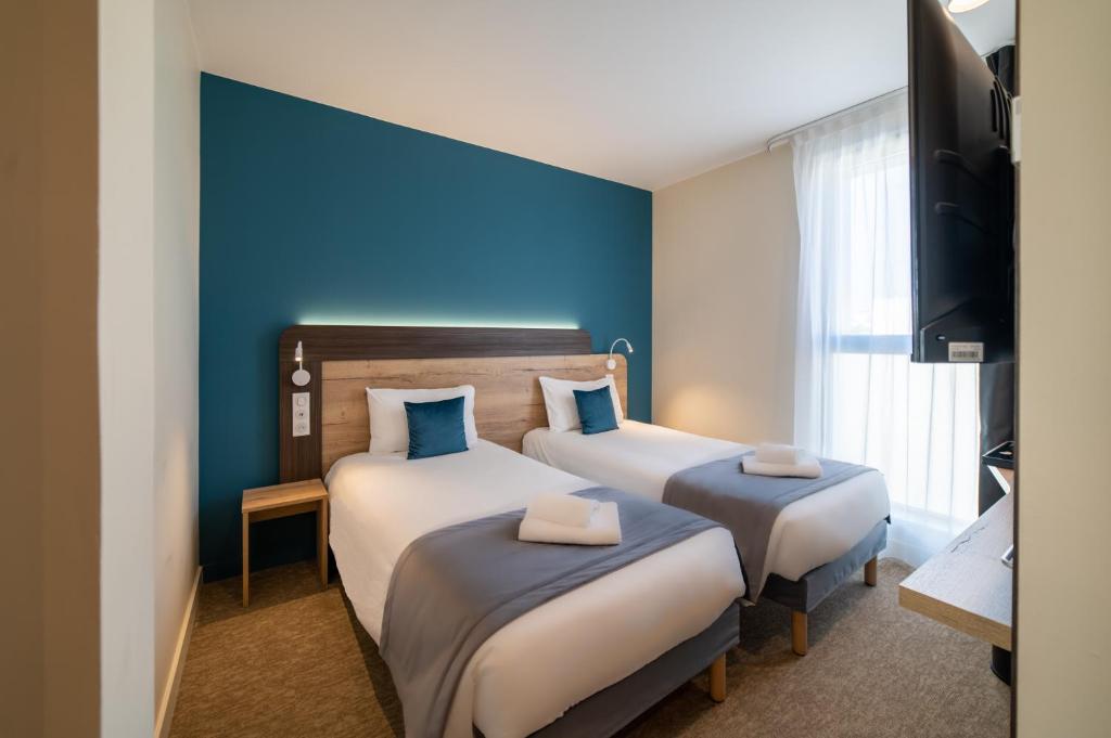 Postel nebo postele na pokoji v ubytování Hôtel - Restaurant Le MITIGANA