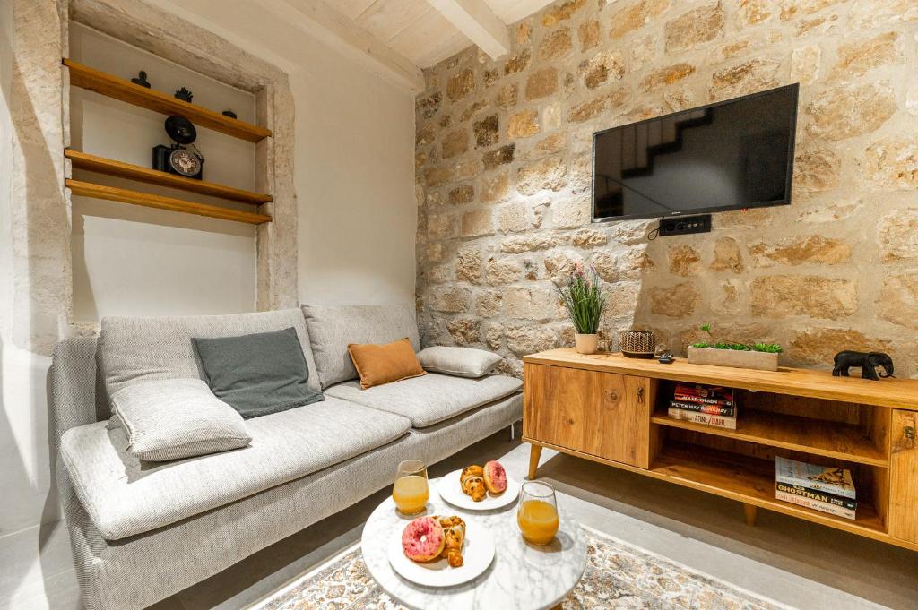 a living room with a couch and a tv at Superior 2 Bedroom Apartment Gabriela in Dubrovnik