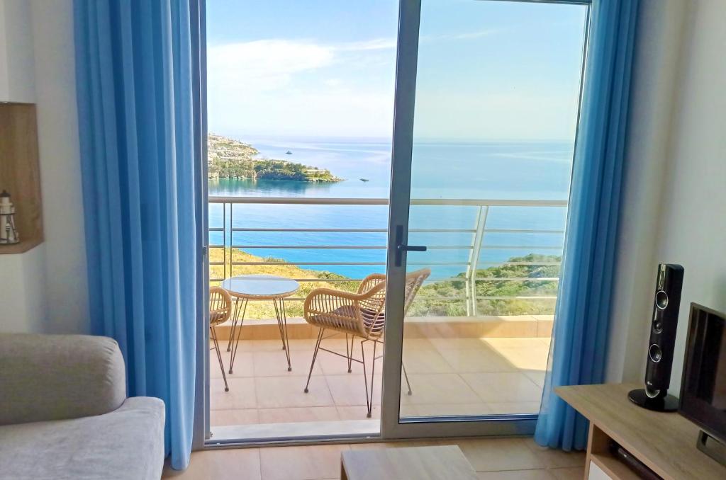 a room with a balcony with a view of the ocean at Between 2 beaches - sea breeze suite in Ligaria