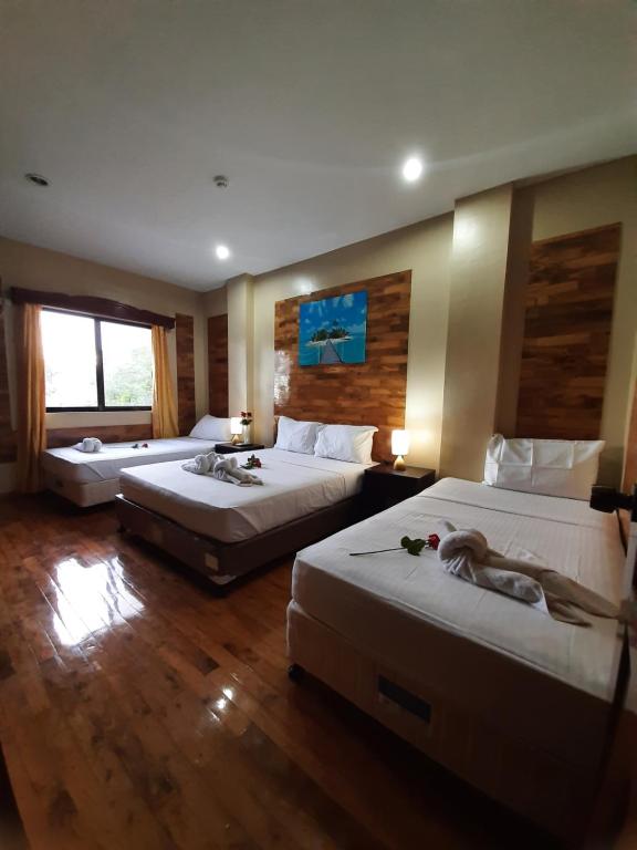Postel nebo postele na pokoji v ubytování Mabini Hotel