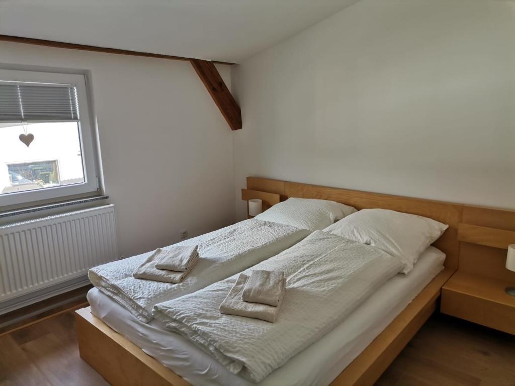 a bedroom with a bed with two pillows on it at Ferienwohnung Neukalen in Neukalen