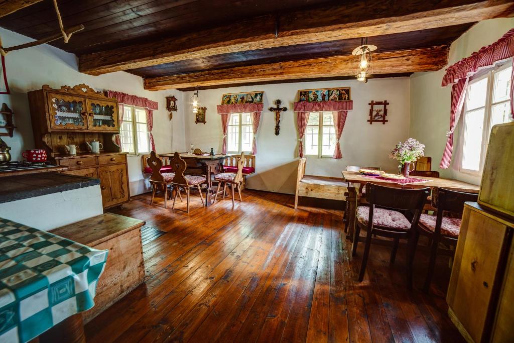 a kitchen and dining room with a table and chairs at Chaloupka Prischlop in Velké Karlovice