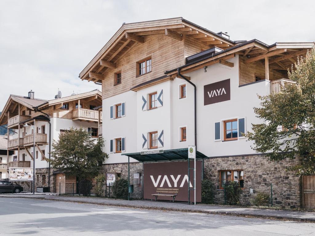 a large white building with a wooden roof at VAYA Kaprun in Kaprun