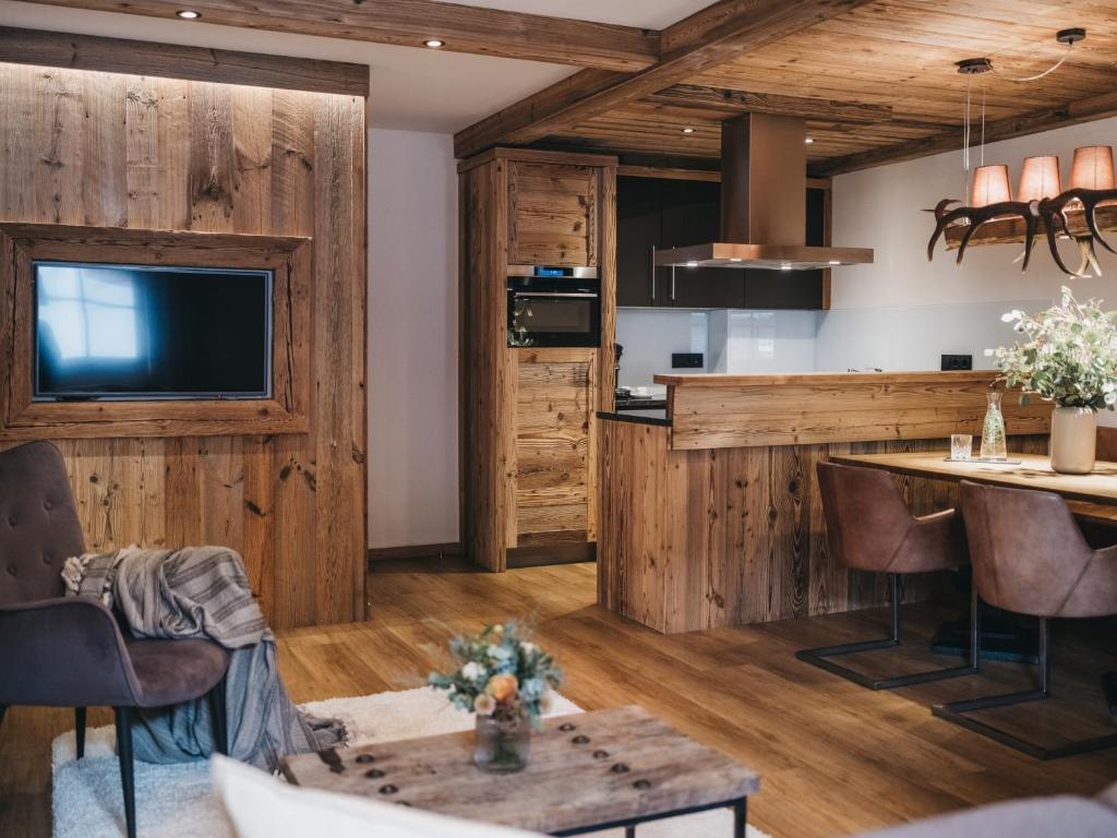 a kitchen and living room with wood paneling at VAYA Kaprun inklusive Zell am See Kaprun Sommer Karte in Kaprun