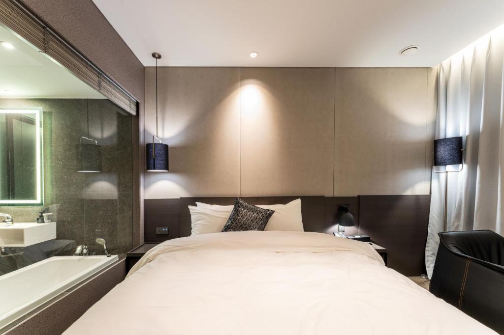 Postel nebo postele na pokoji v ubytování Hotel SoulHada