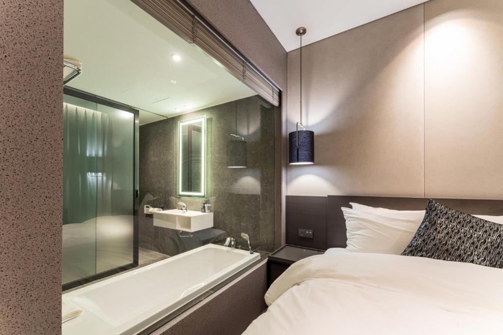 Postel nebo postele na pokoji v ubytování Hotel SoulHada