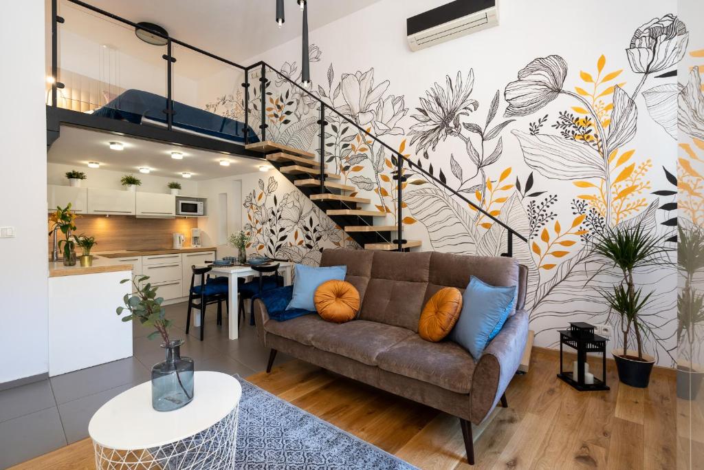 a living room with a couch and a staircase at Home Sweet Home in Krakow