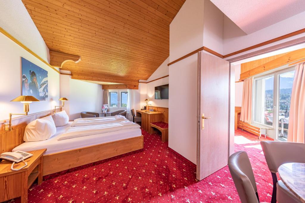 Postel nebo postele na pokoji v ubytování T3 Alpenhotel Flims