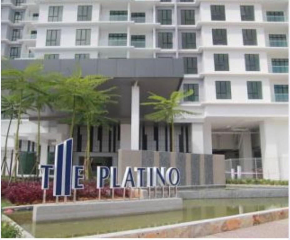 a building with a hotel sign in front of it at Pangsapuri Putra Mewah in Johor Bahru