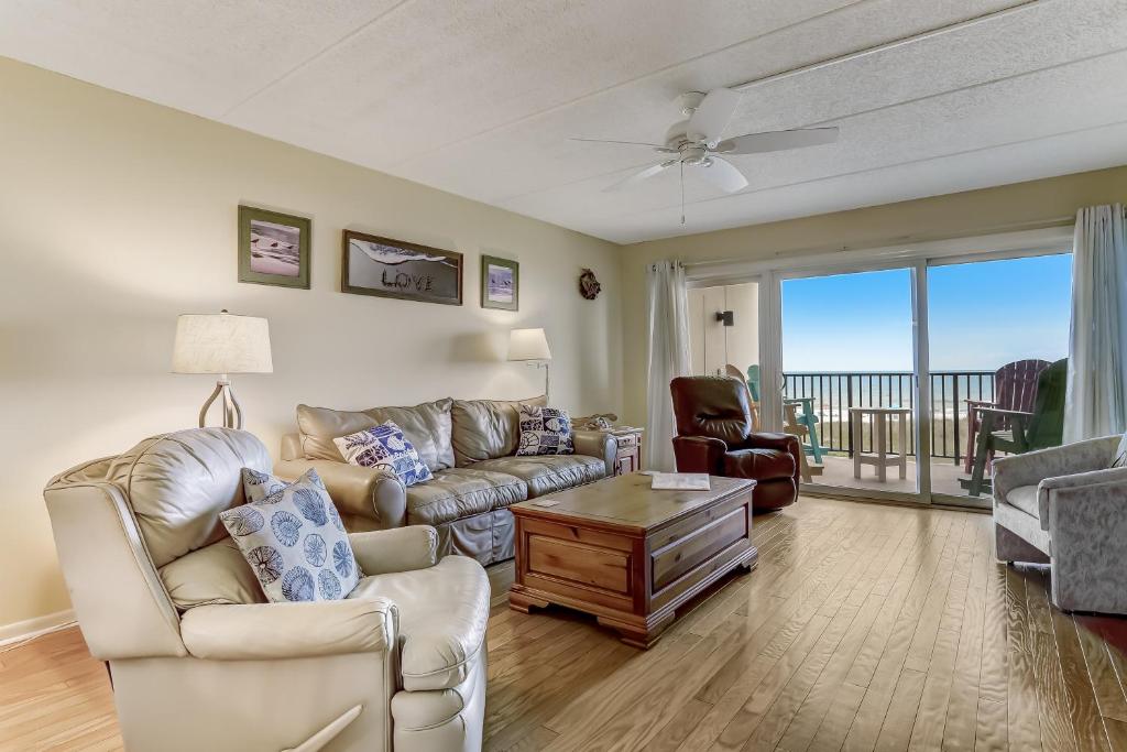 a living room with a couch and a table at Amelia South Beach Condo in Fernandina Beach