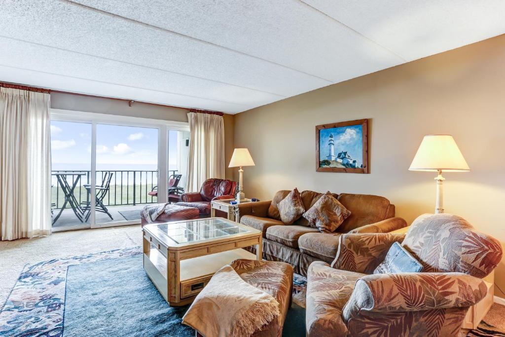 a living room with a couch and a table at Fresh Oceanfront Condo in Fernandina Beach